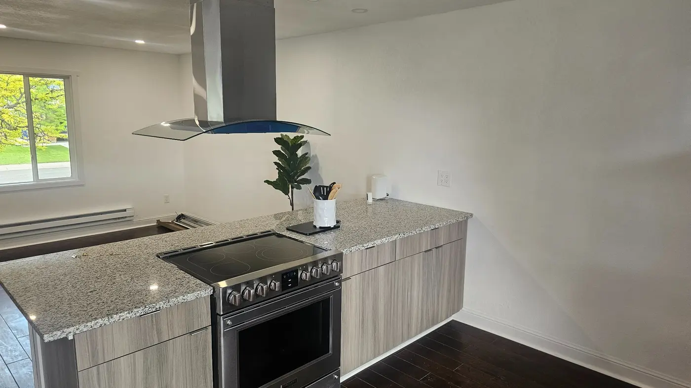 Finished kitchen remodel with electric range and lighting